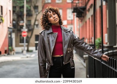 Happy african american woman with curly hair smiling. Beautiful young female walking and having fun in New York city - Powered by Shutterstock