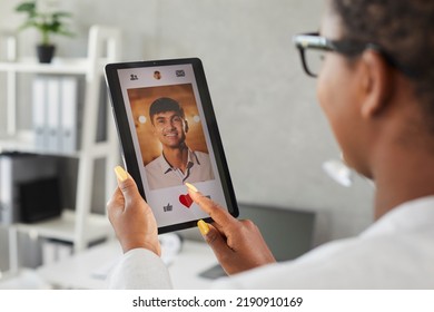 Happy African American Woman Gives Like To Profile Pic Of Handsome Caucasian Man On Modern Love App Or Online Dating Website. Close Up Hands And Tablet. Woman Looking For Husband For Biracial