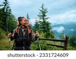 Happy African American woman hiking in nature and looking away. Copy space.