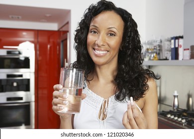 Happy African American Woman Taking Pill