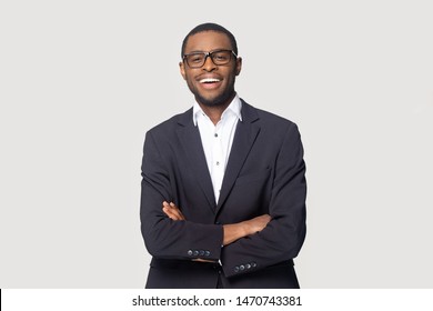 Happy african american young businessman in formal suit wearing eyeglasses portrait. Smiling millennial confident black guy posing for photo, looking at camera, isolated on grey studio background. - Powered by Shutterstock