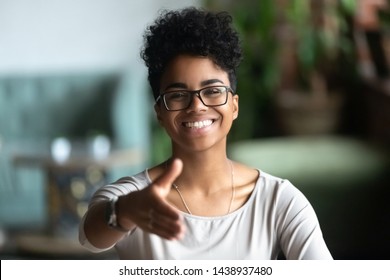 Happy african American young woman in glasses stretch hand for handshake greeting introducing to someone, smiling black biracial millennial female hr agent in spectacles get acquainted at meeting - Shutterstock ID 1438937480