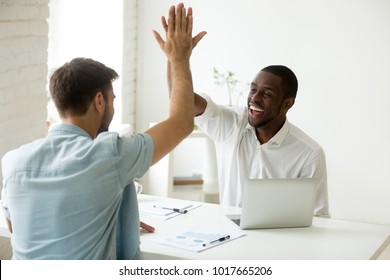 Happy African And Caucasian Businessmen Giving High Five In Office, Diverse Motivated Colleagues Partners Team Celebrating Good Work Result Or Business Success, Showing Unity Help Support In Teamwork