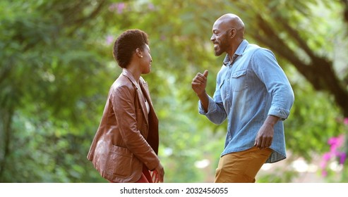 Happy African Couple Dancing Celebrating Outside In Street. Two People Dance