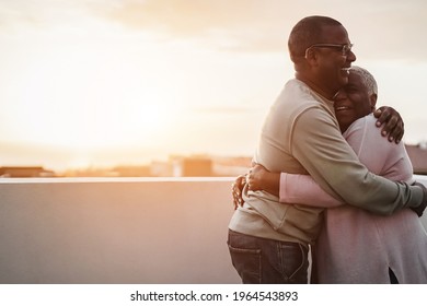 Happy african couple dancing outdoors at summer sunset - Focus on man face