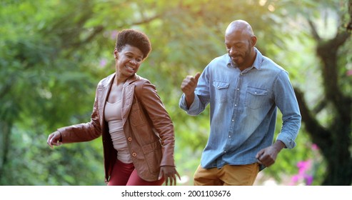 Happy African Couple Dancing Outside Celebrating