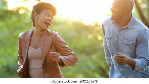 Happy African Couple Dancing Outside Celebrating