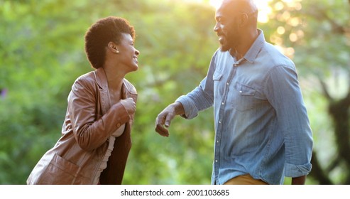 Happy African Couple Dancing Outside Celebrating