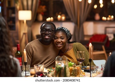 Happy African couple sitting at the table