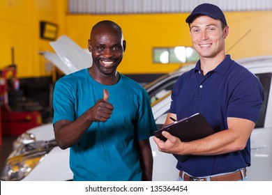 happy african customer giving thumb up in car repair shop