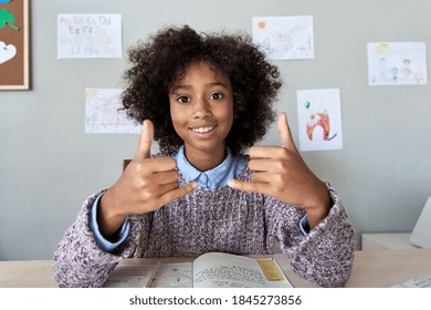 Happy African Deaf Mute Kid School Girl Learning Online Class On Laptop Looking At Webcam Communicating By Video Conference Call Using Sign Language Showing Play Gesture On Virtual Therapy, Headshot.