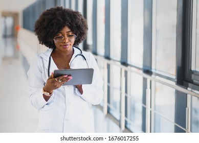 Happy African Doctor Using Tablet Computer