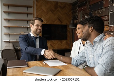 Happy African Family After Sign Contract Shake Hands Bank Advisor. Make Financial Deal At Meeting, Successful Negotiations, Real Estate Buyers Making Deal With Male Broker Agent, Take Mortgage Concept