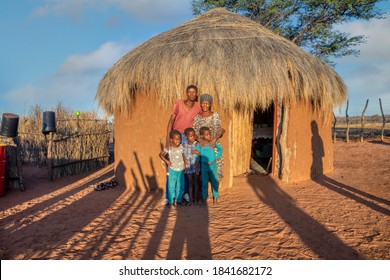 Happy African Family In Front Of The Hut, Village In Botswana