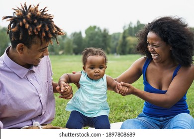 Happy African Family Having Fun Together In Public Park - Black Father And Mother Enjoying Time With Their Daughter - Focus On Female Face