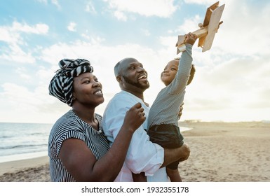 Happy African Family Having Fun On The Beach During Summer Vacation - Parents Love And Unity Concept