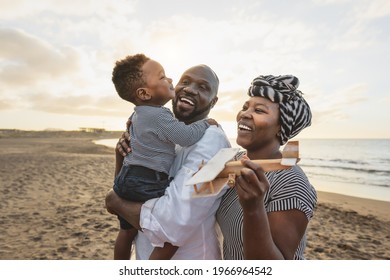 Happy African Family Having Fun On The Beach During Summer Vacation - Parents Love And Unity Concept