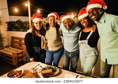 Happy african family having fun eating together during Christmas time - Holiday concept - Main focus on father face - Powered by Shutterstock