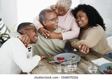 Happy African Family Having Tender Moment Eating Lunch At Home - Main Focus On Daughter Face