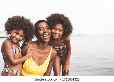 Happy African Family On The Beach During Summer Holidays - Afro American People Having Fun On Vacation Time - Parents Love And Travel Lifestyle Concept