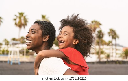 Happy African Family On The Beach During Summer Holidays - Afro American People Having Fun On Vacation Time - Parents Love And Travel Lifestyle Concept