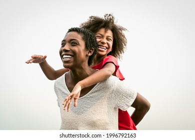 Happy African Family On The Beach During Summer Holidays - Afro People Having Fun On Vacation Time - Parents Love And Travel Lifestyle Concept