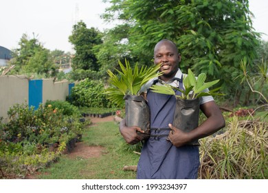 Happy African Farmer Holding Two Potted Plants