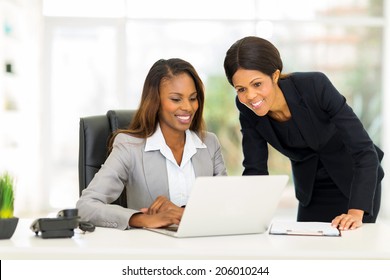 happy african female colleagues working in office - Shutterstock ID 206010244