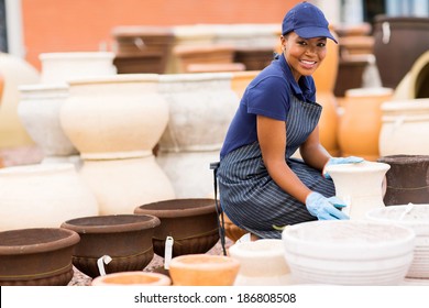 Happy African Female Hardware Store Worker Selling Flower Pot