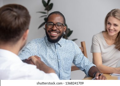 Happy African Hr Recruit Manager Handshake Hire Candidate At Business Interview, Smiling Black Recruiter Employer Shake Hand Employ Congratulate New Worker Made Good First Impression Got Job Concept