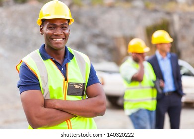 Happy African Industrial Worker With Arms Folded