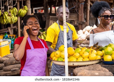 Happy African Lady Making A Phone Call In A Market