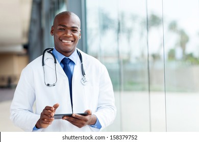 happy african male doctor with tablet computer