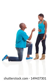 happy african man down on his knee proposing to girlfriend when she is pregnant 