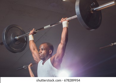 happy african man working out with barbell - Shutterstock ID 678289954