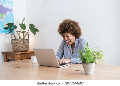 Happy African Mature Woman Using Laptop Computer At Home Office - Focus In Face