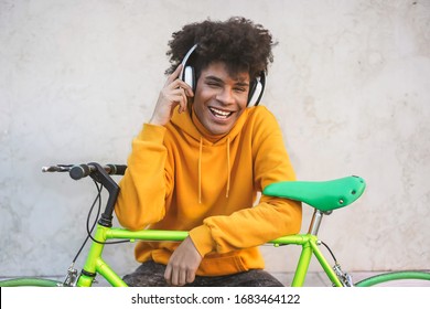 Happy African Millennial Guy Listening Music Playlist Outdoor - Young Man Having Fun With Technology Trends - Tech, Generation Z And Stylish Concept - Focus On Face