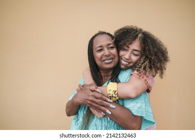 Happy african mother and adult daughter hugging together outdoor - Family love - Shutterstock ID 2142132463