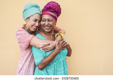 Happy african mother and daughter hugging each others - Focus on senior woman face