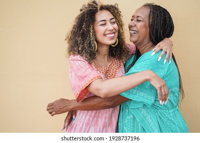 Happy african mother and daughter hugging each others - Love and family concept