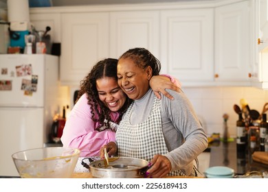 Happy African mother and daughter preparing a homemade dessert - Shutterstock ID 2256189413