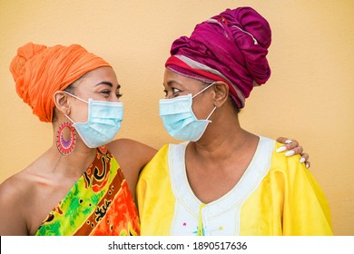 Happy African Mother And Daughter Wearing Safety Masks - Focus On Faces