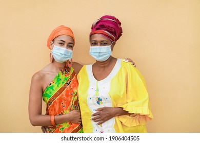 Happy African Mother And Daughter Wearing Safety Masks - Focus On Faces