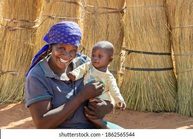 happy African mother with her child in a village in Botswana - Powered by Shutterstock