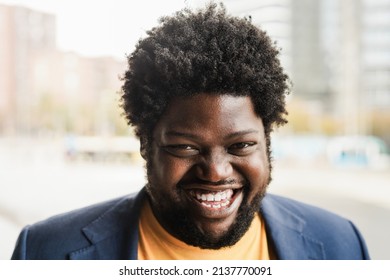 Happy african plus size man smiling on camera outdoor - Focus on face