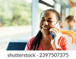 Happy African senior woman having a call with smartphone while traveling by bus