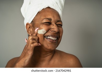 Happy African Senior Woman Having Skin Care Spa Day - People Wellness Lifestyle Concept