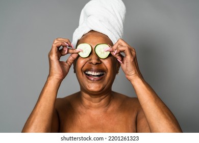 Happy African senior woman having skin care spa day - People wellness lifestyle concept - Powered by Shutterstock