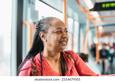 Happy African senior woman traveling with public tram - Powered by Shutterstock