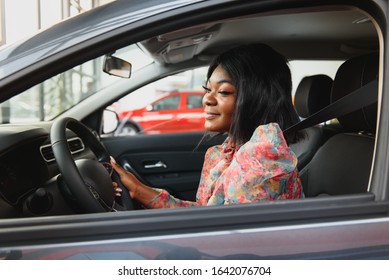 Happy African Woman Driving A New Car